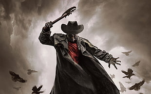 man holding axe and wearing black coat and black hat