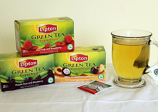 Lipton green tea box near to tea cup