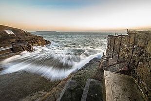rock jetty and body of water, sandycove, dublin, ireland