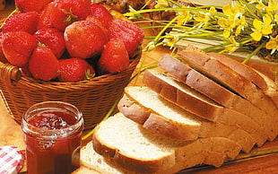 slice of loaf bread near basket of strawberries