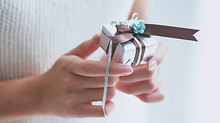 person holding small gift box HD wallpaper