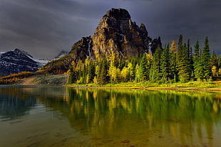 landscape photography of mountain by the body of water beside