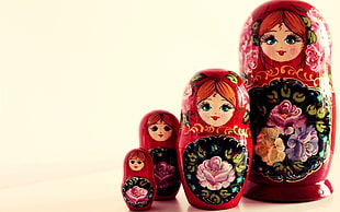 four red-and-black matryoska dolls