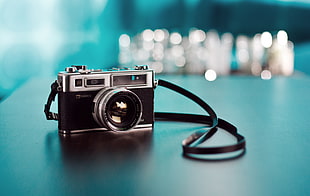 selective focus photography of film camera on gray table