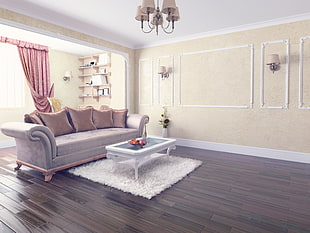 brown velvet sofa with throw pillows on brown parquet flooring