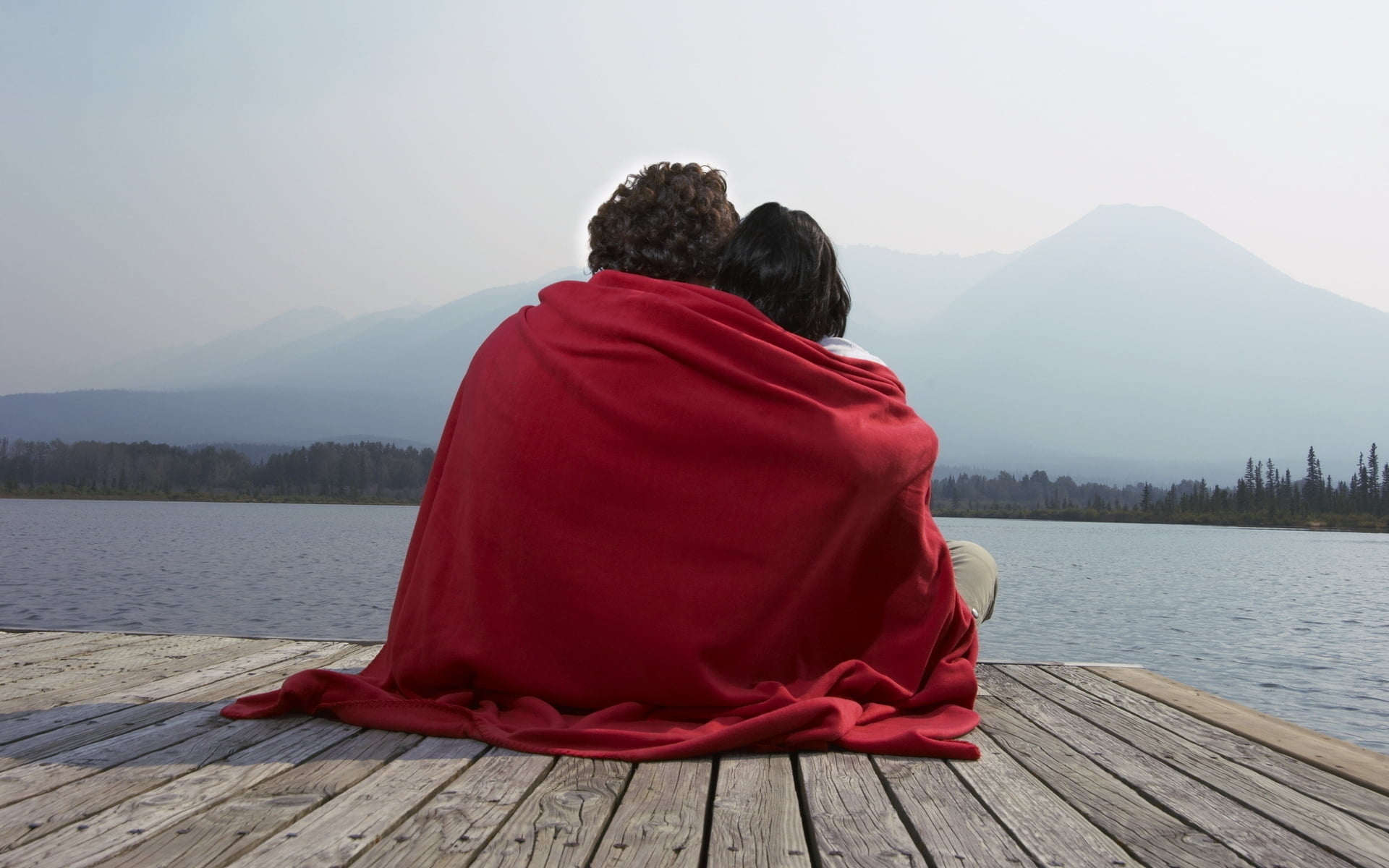 landscape photography of two person sitting on boat dock