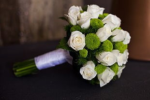 tilt shift lens photography of white and green wedding bouquet