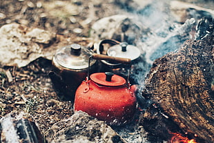 selective focus photography of three kettles on fire