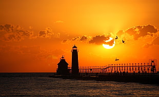 Silhoute photo of Lighthouse during sunset HD wallpaper