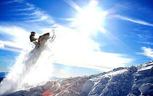 man riding snow mobile during daytime