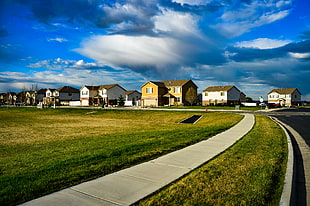 landscape photograph of a village near the green grass field HD wallpaper