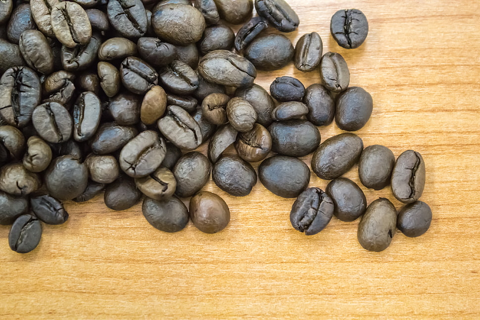 coffee beans on brown wooden surface HD wallpaper
