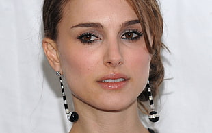woman wearing black-and-white striped drop earrings