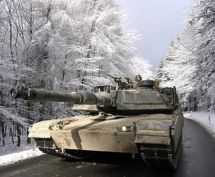 beige army tank on a snowy field