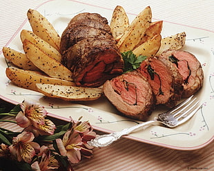 cook meat and fried potato on plate