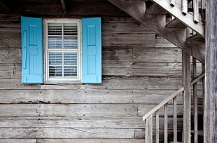 white and teal wooden window opened during daytime