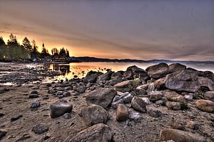 panoramic photo of stone near the ocean under the sunset, lake tahoe