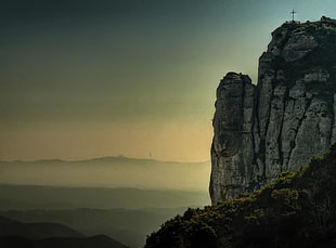 cross on mountain with golden hour background, montserrat