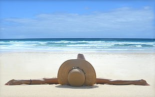female lying on white sand near seashore during daytime, fiano, fuerteventura, gran