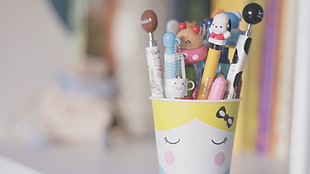 assorted pencil in white and yellow cup