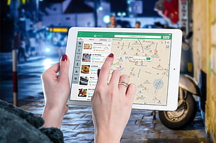 person holding white iPad
