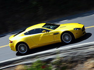 yellow Ferrari sports coupe crossing road during daytime
