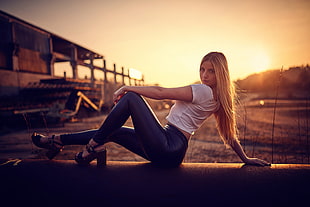 women's white crop shirt and black leather leggings, women, blonde, sitting, sunset