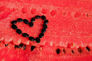 closeup photography of watermelon seeds formed heart-sign