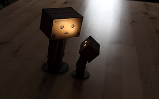 shallow focus photography of two brown cardboard box lamps