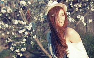 woman in white off-shoulder dress wearing beige hat photography