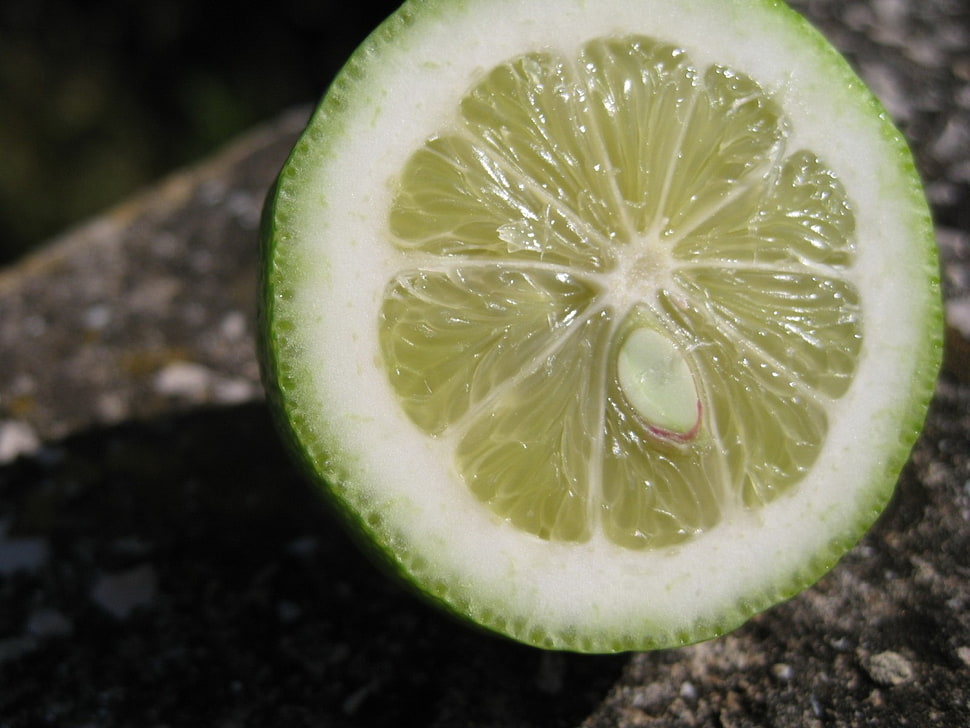green lemon on brown surface HD wallpaper