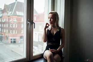 woman sitting on window