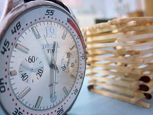selective focus photography of white and silver-colored chronograph watch