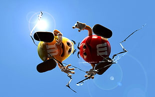 red and yellow M&M standing on clear broken glass