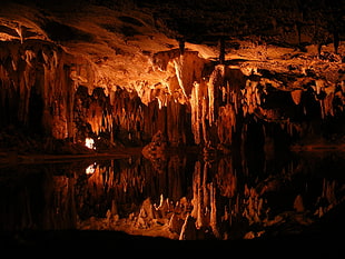 brown stalagmites and stalactites, cave, water
