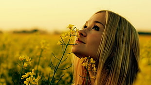 woman smelling flowers HD wallpaper