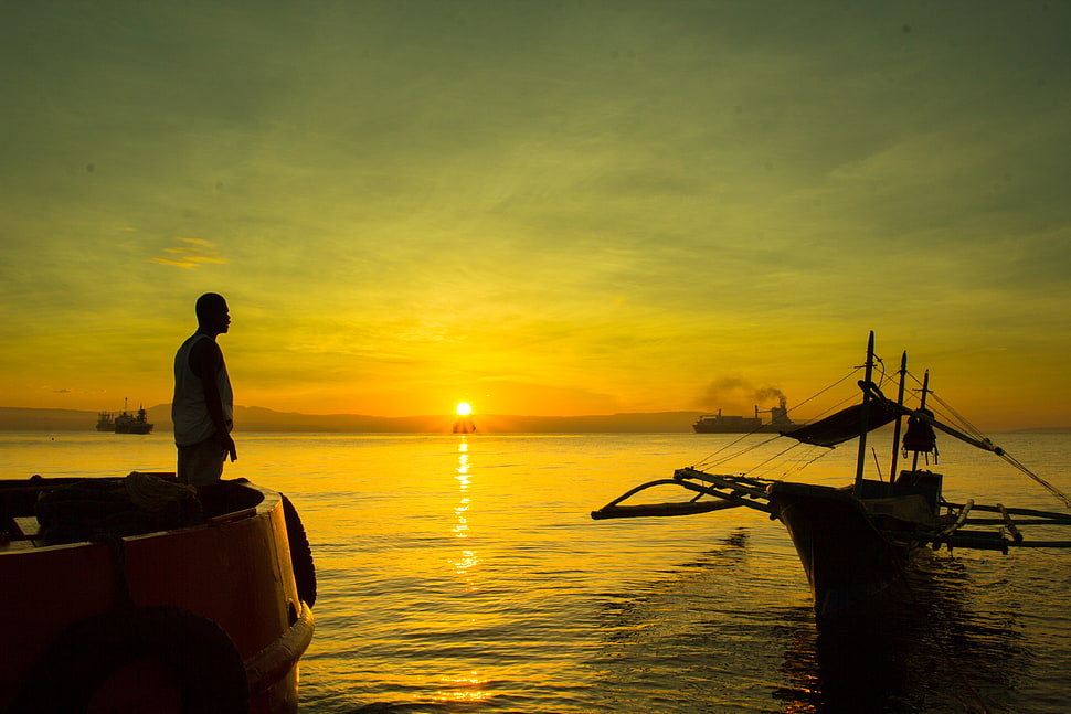 man standing on boat during sunrise, davao, philippines HD wallpaper