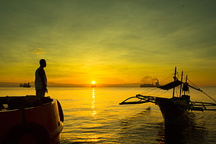man standing on boat during sunrise, davao, philippines