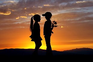 two silhouette of girl and boy facing each other HD wallpaper