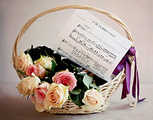 pink and yellow roses in woven basket