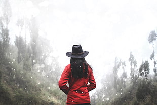 woman in red jacket and black cowgirl hat during daytime