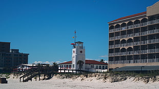 white and brown concrete building, beach