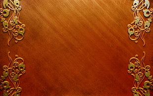 brow and gold-colored floral emboss wooden surface