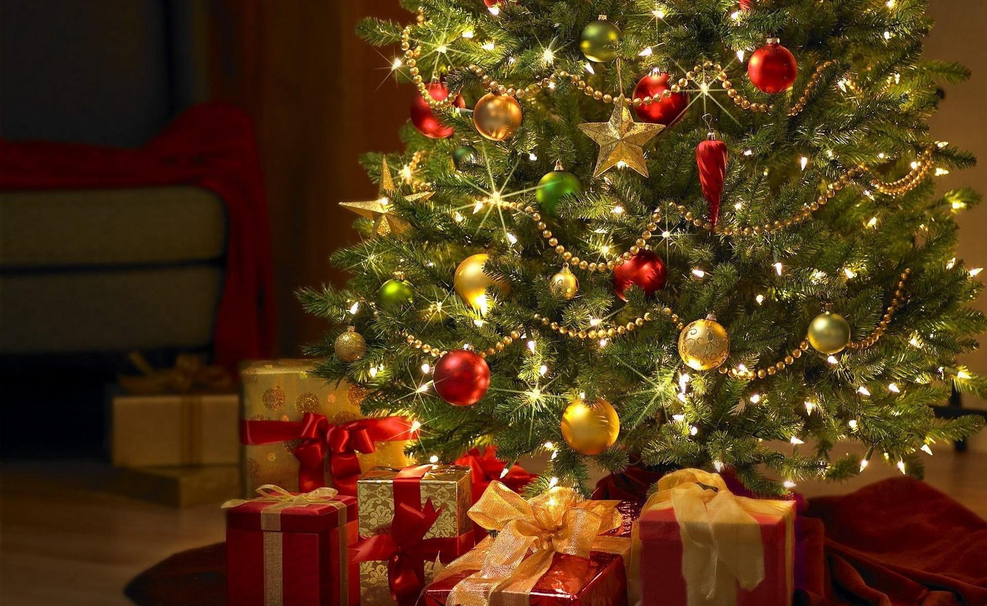 green christmas tree with string lights and Christmas baubles