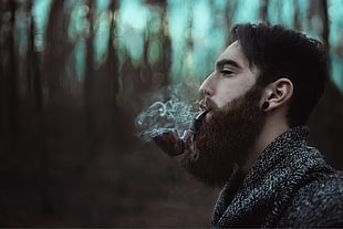 man smoking tobacco pipe