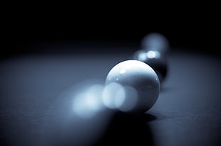 white marble ball in shallow focus photography