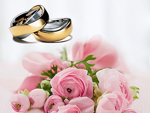 selective focus photography of pink rose bouquet and gold-and-silver engagement ring