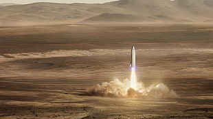 white rocket launching on brown desert field HD wallpaper