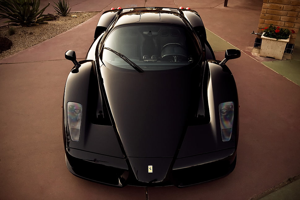 black Ferrari Enzo on parking lot HD wallpaper