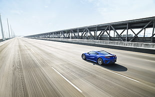 timelapse photo of blue car along highway during daytime